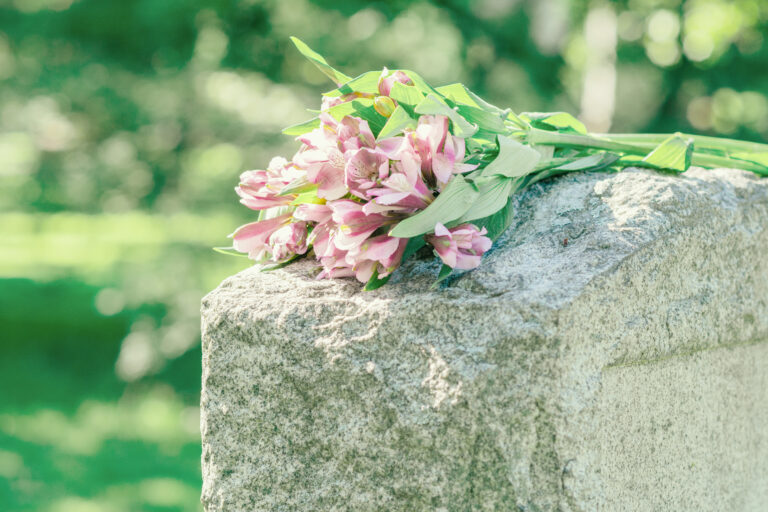 pink flowers resting on a headstone for buchanan group