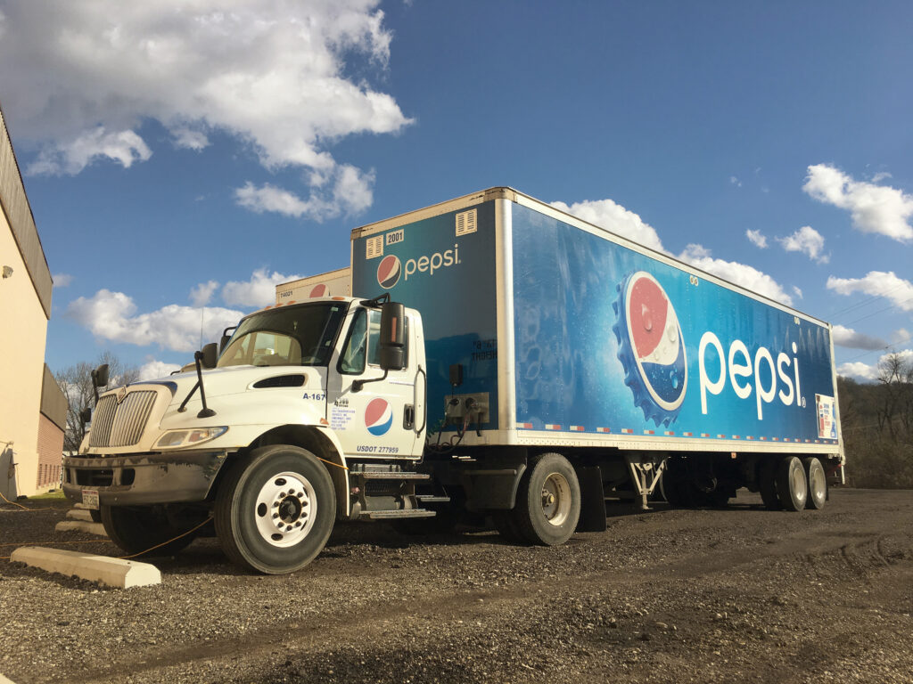 pepsi truck driving on the road