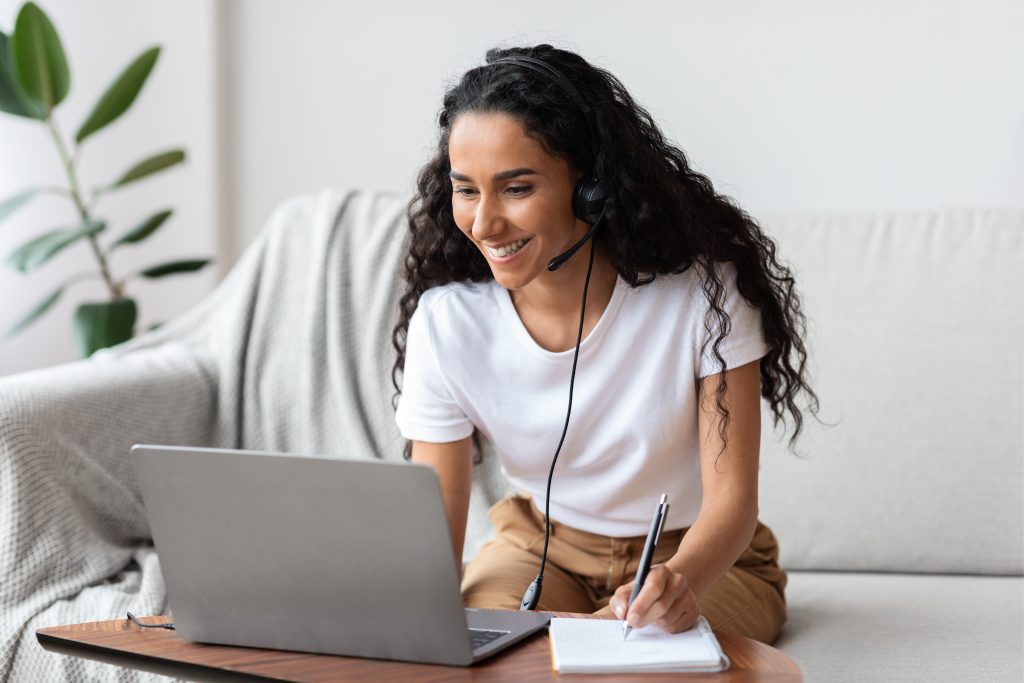 joyful-young-woman-studying-online-using-laptop